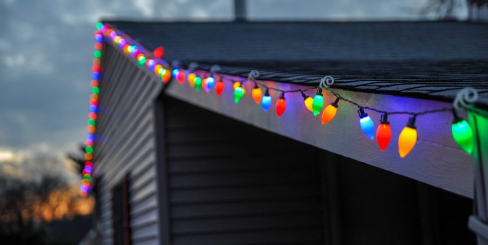 Colorful christmas lights around roof on house