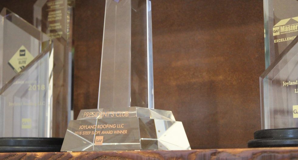 Joyland Roofing steep slope award glass trophy on shelf