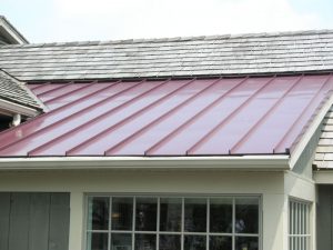 roof of a house with partial red metal roofing