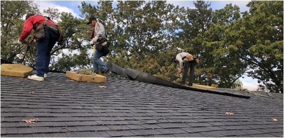Men on roof installing roofing system