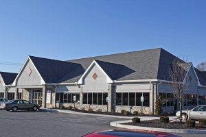 gray commercial building with shingle roofing