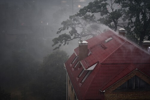 Home with red roof in a storm