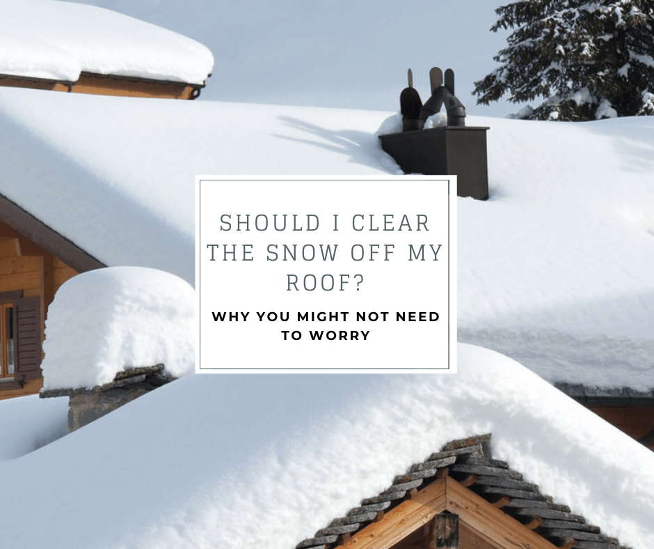 snow covered metal roof with the caption "should I clear the snow off my roof? Why you might not need to worry"