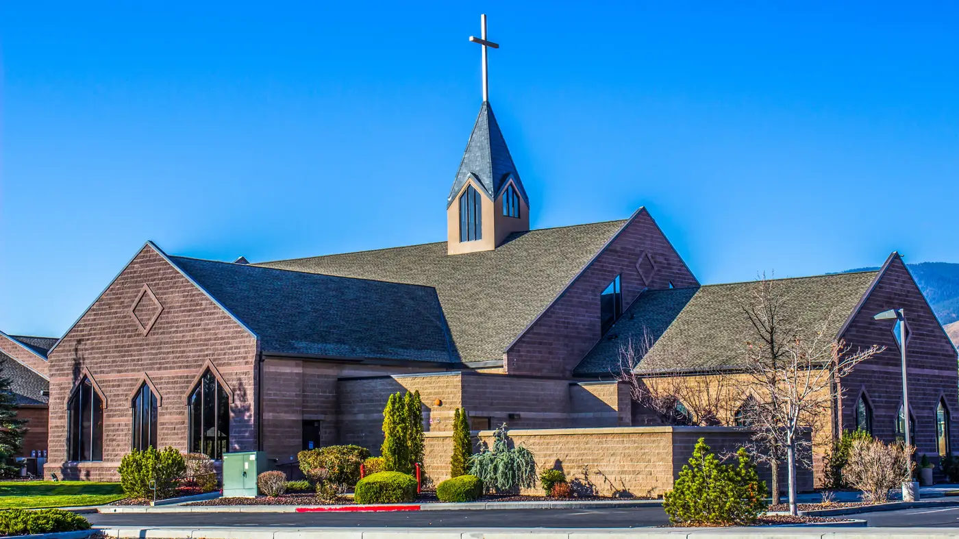 A church with a gray roof in Lancaster County, PA, by Joyland Roofing.