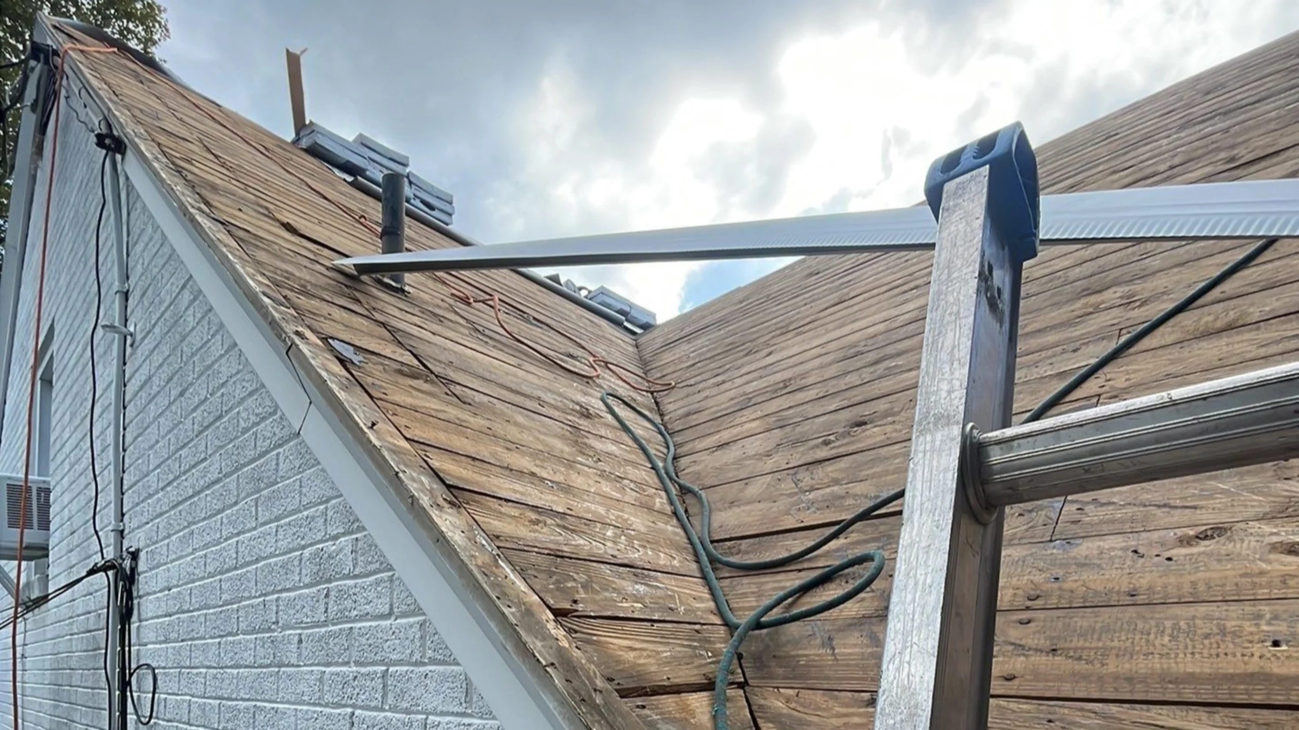 The roof of a house in the middle of repairs in Lancaster County, PA, by Joyland Roofing.