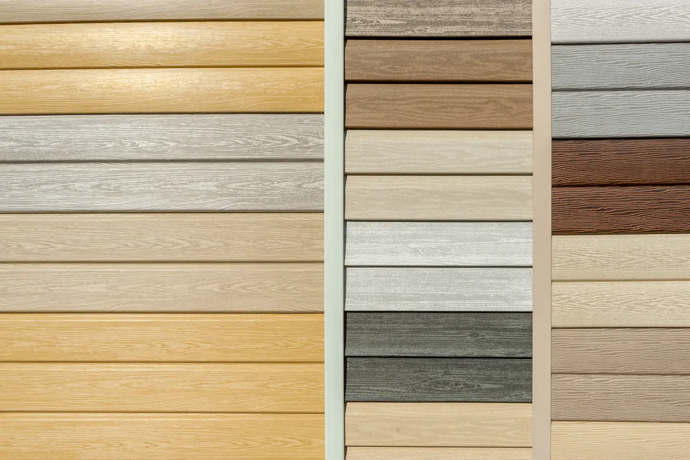 Samples of vinyl siding imitation wood in various colors and stains