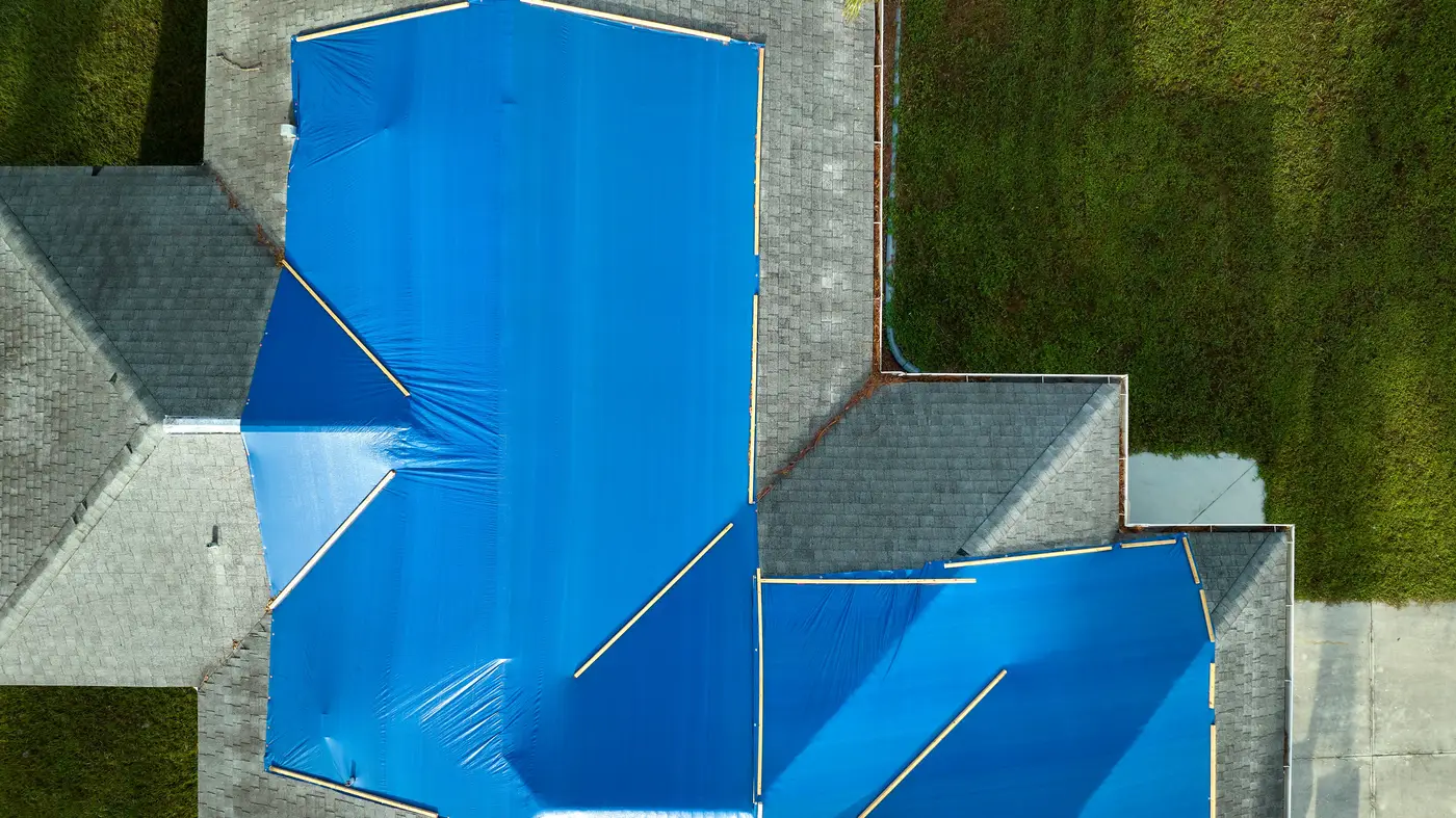 View of leaking asphalt  roof from above with blue tarp in York County, PA