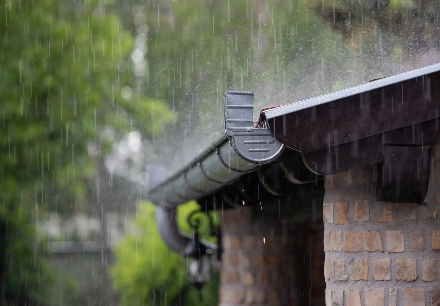 Heavy rain on metal gutter and roof