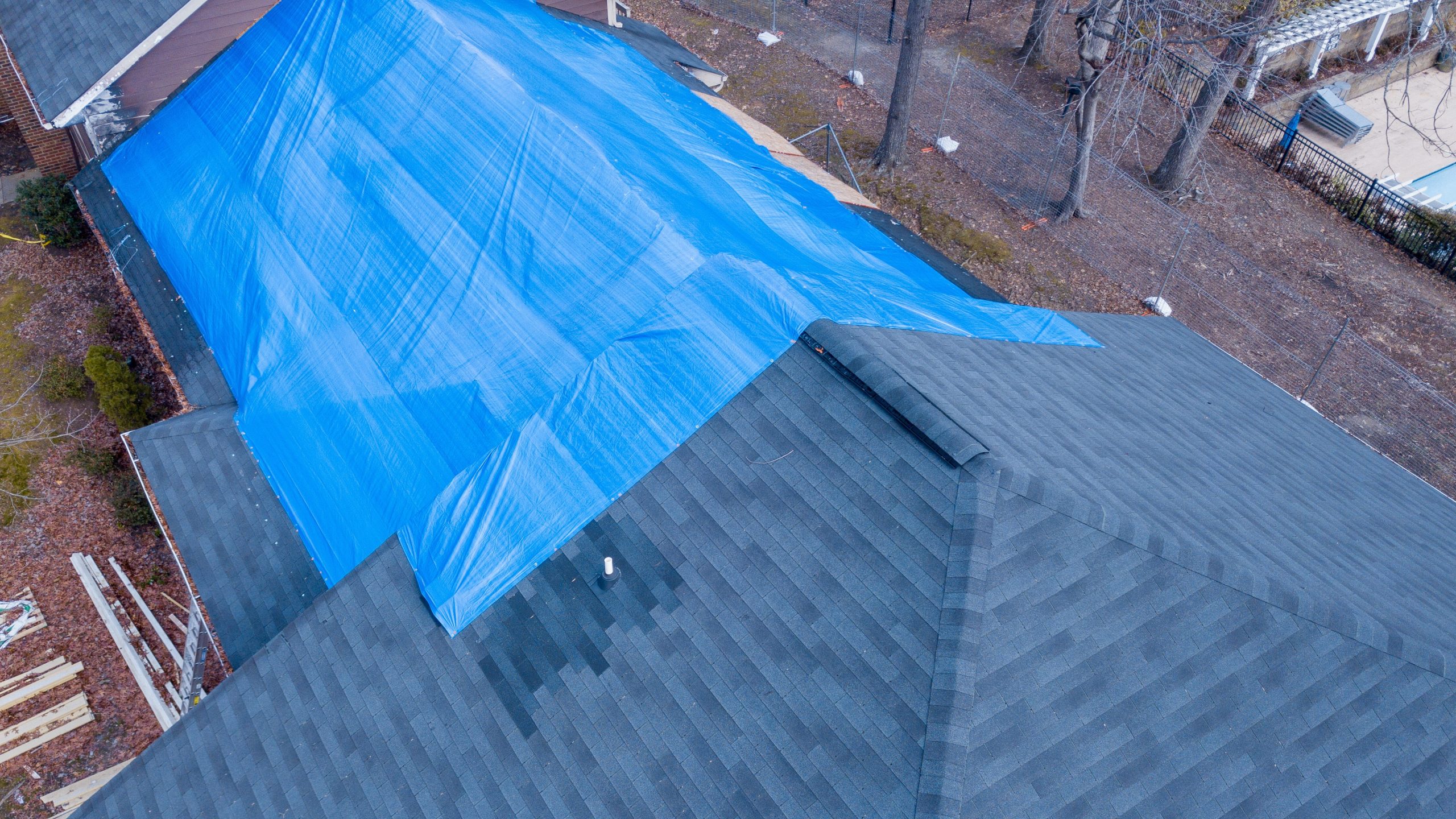 A large blue tarp over part of an apartment building roof in Mechanicsburg, PA.
